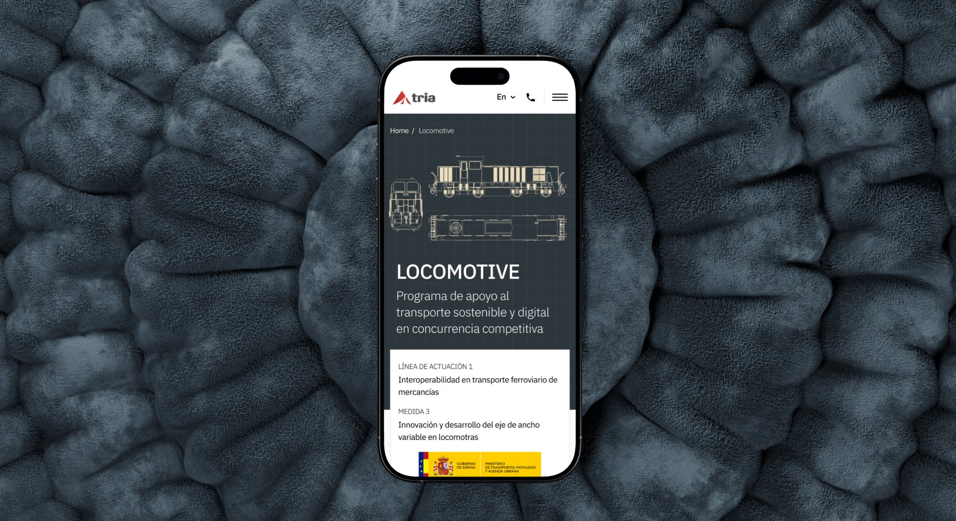 Pantalla responsiva de Tria Ingeniería mostrando un programa de apoyo al transporte sostenible y digital.